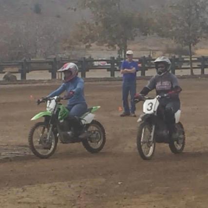 Two students practicing side by side on the dirt bike range